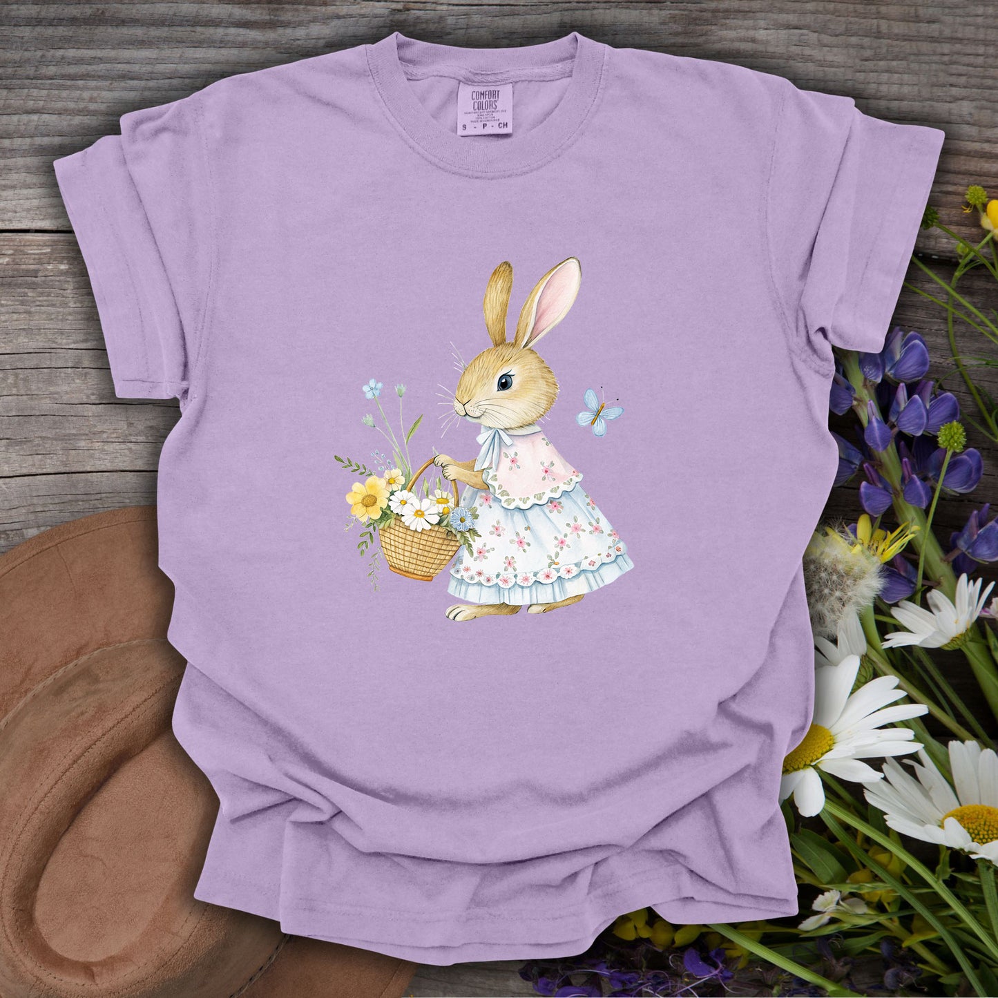 Orchid S-size t-shirt with a watercolor bunny in a floral dress holding a spring flower basket.