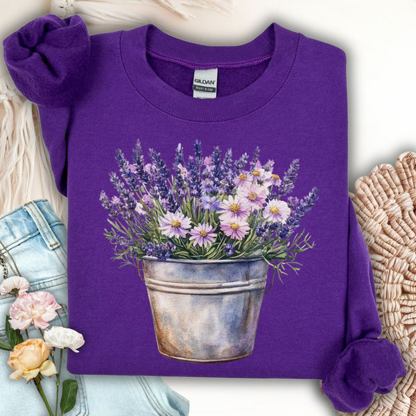 Purple Gildan sweatshirt with a hand-painted style lavender and daisy bouquet in a weathered metal pot.