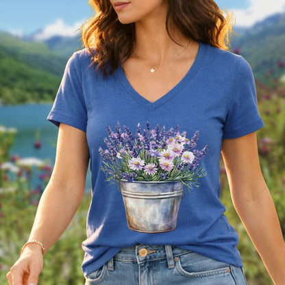 Blue v-neck tee with a faded botanical print of lavender and daisies in a rustic metal pot.