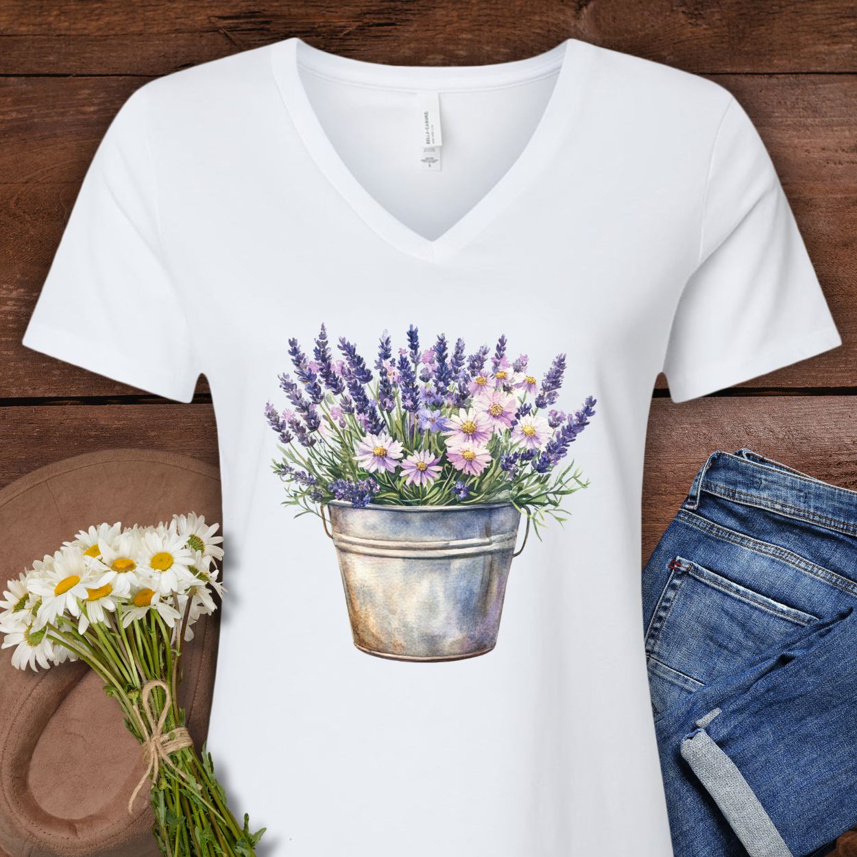 White v-neck tee with a faded botanical print of lavender and daisies in a rustic metal pot.