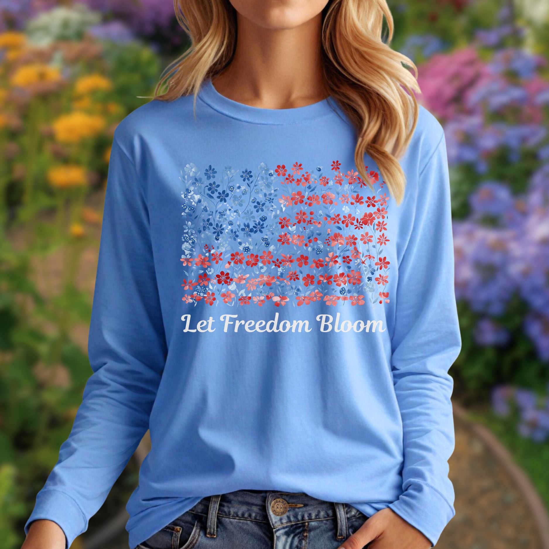 Light blue long sleeve tee with a faded red and blue floral flag graphic and "Let Freedom Bloom" text.