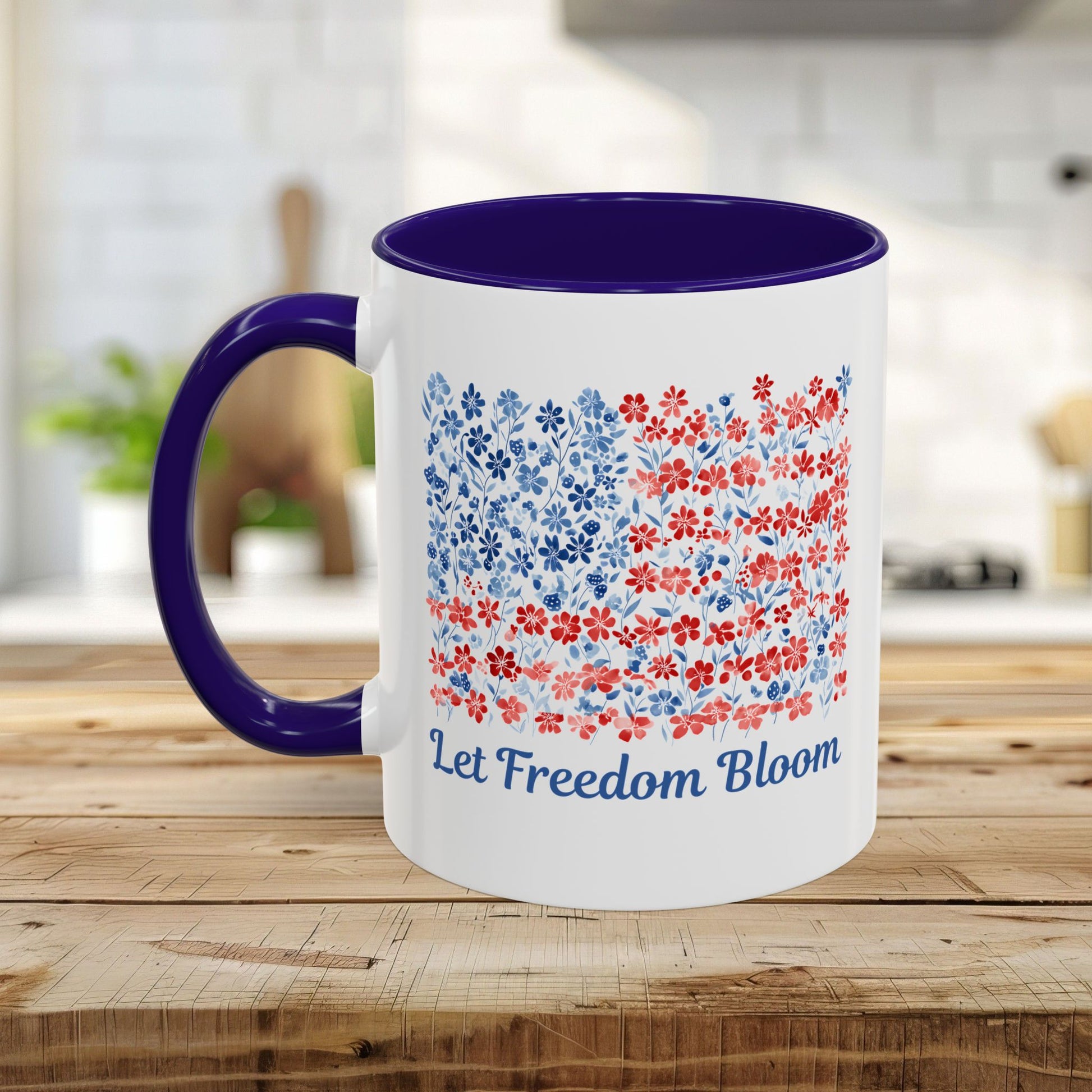 White ceramic mug with a navy handle and interior, featuring a floral flag design and "Let Freedom Bloom.