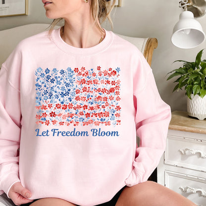 Pink cotton-poly sweatshirt with a floral American flag design and "Let Freedom Bloom" in blue script.