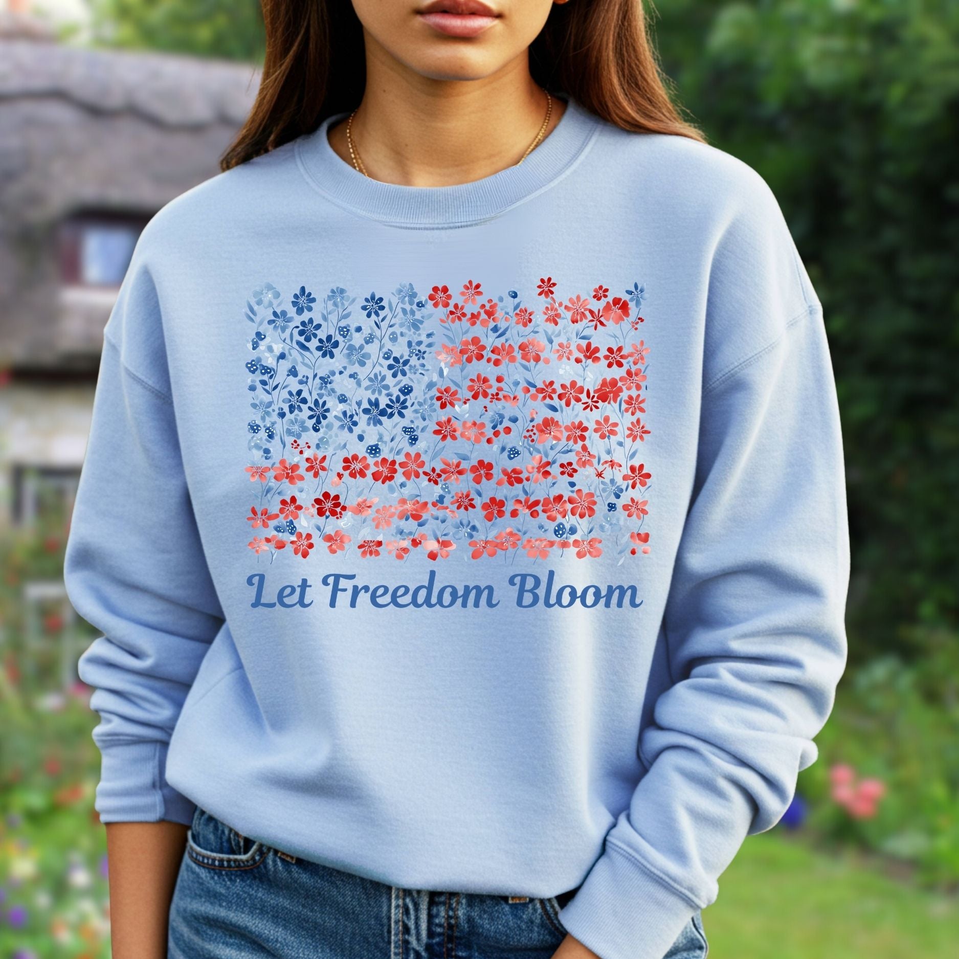 Light blue cotton-poly sweatshirt with a floral flag design and "Let Freedom Bloom" text.