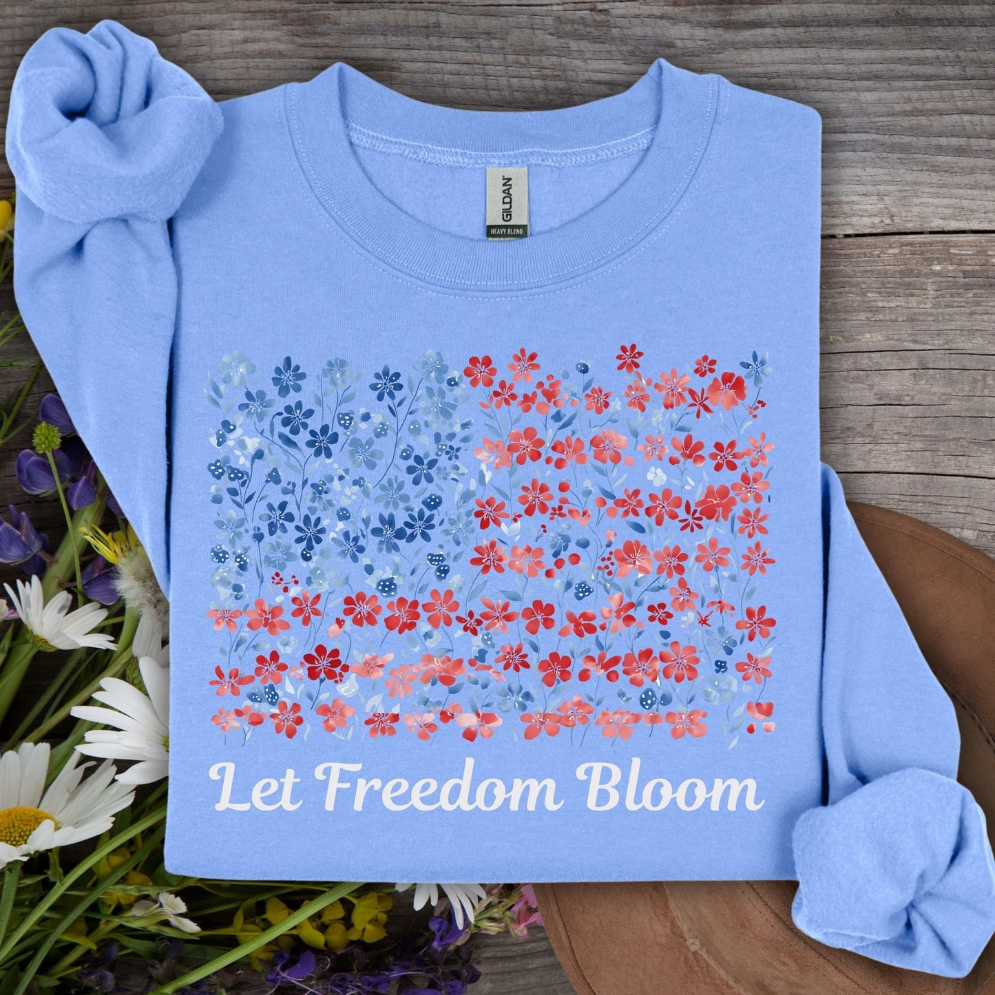 Carolina Blue sweatshirt with a floral flag design and "Let Freedom Bloom" text, made from a cotton-poly blend.