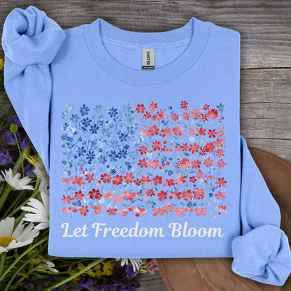 Carolina Blue sweatshirt with a floral flag design and "Let Freedom Bloom" text, made from a cotton-poly blend.
