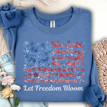 Indigo blue crewneck sweatshirt with a floral flag design and "Let Freedom Bloom" text.