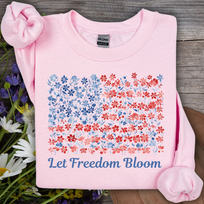Light pink crewneck sweatshirt with a floral flag design and "Let Freedom Bloom" text.