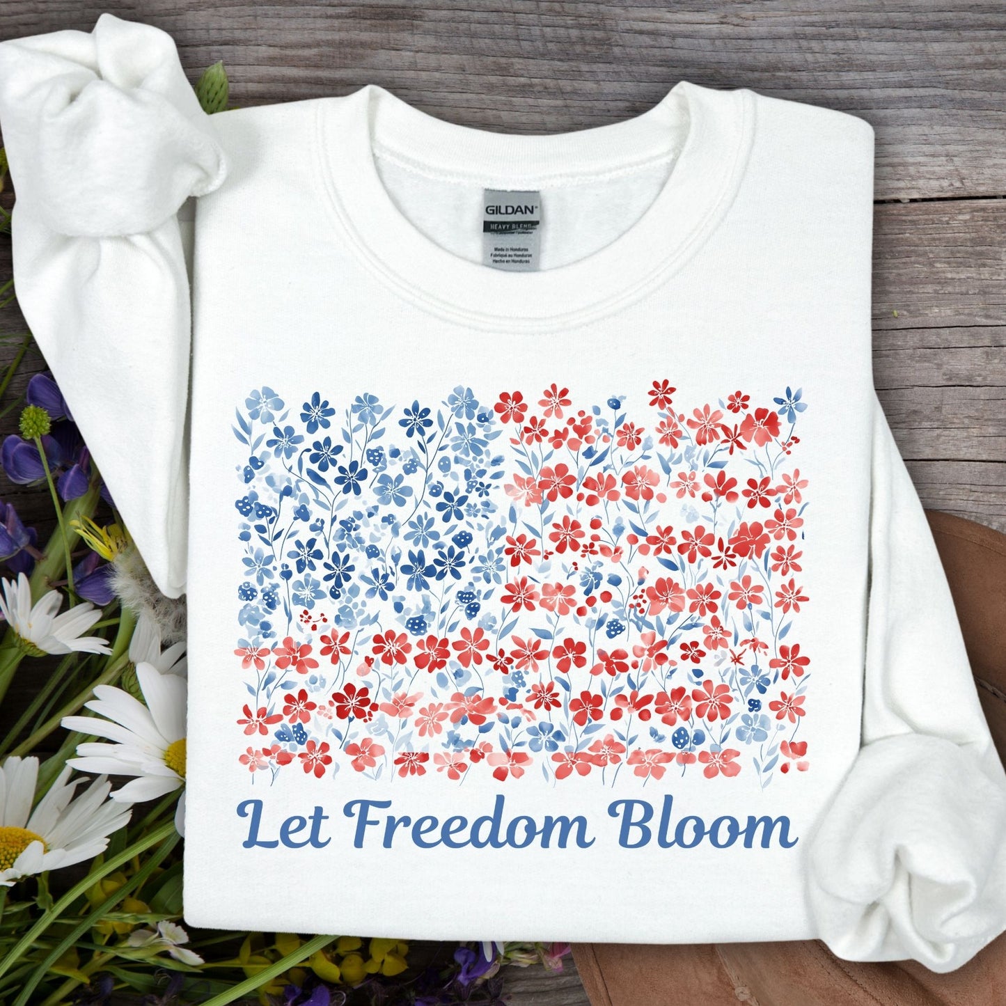 White cotton-poly sweatshirt with a floral flag design and "Let Freedom Bloom" text.