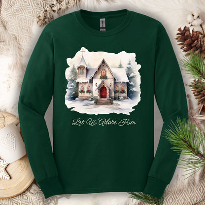 Forest Green heavyweight cotton long sleeve tee with a watercolor snow-covered chapel and "Let Us Adore Him" text.