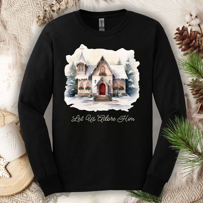 Black long sleeve tee with a watercolor snow-covered country chapel and "Let Us Adore Him" text.