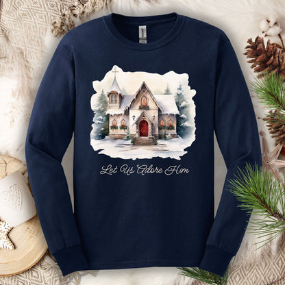 Navy long sleeve tee with a watercolor snow-covered country chapel and "Let Us Adore Him" text.