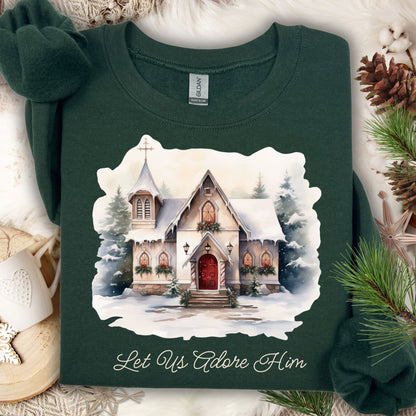 Forest Green Gildan sweatshirt with a snowy country chapel design and "Let Us Adore Him" text.