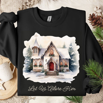 Black Gildan sweatshirt with a snowy country chapel design and "Let Us Adore Him" text.
