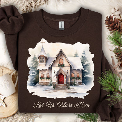 Dark chocolate Gildan fleece sweatshirt with a snowy country chapel design and "Let Us Adore Him" text.