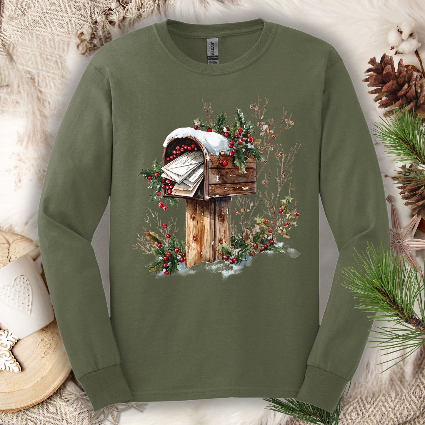 Military Green long sleeve tee with a watercolor rustic mailbox, snow, and holly berries design.