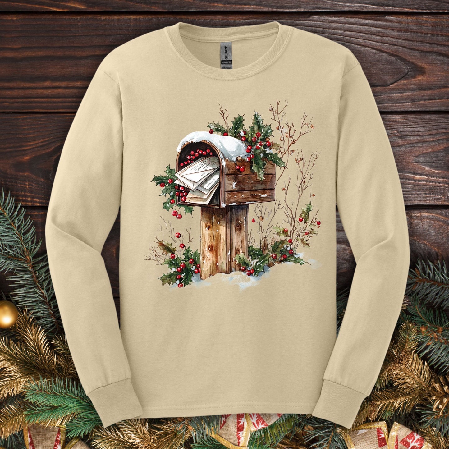 Sand Gildan long sleeve tee with a watercolor vintage Christmas mailbox design.