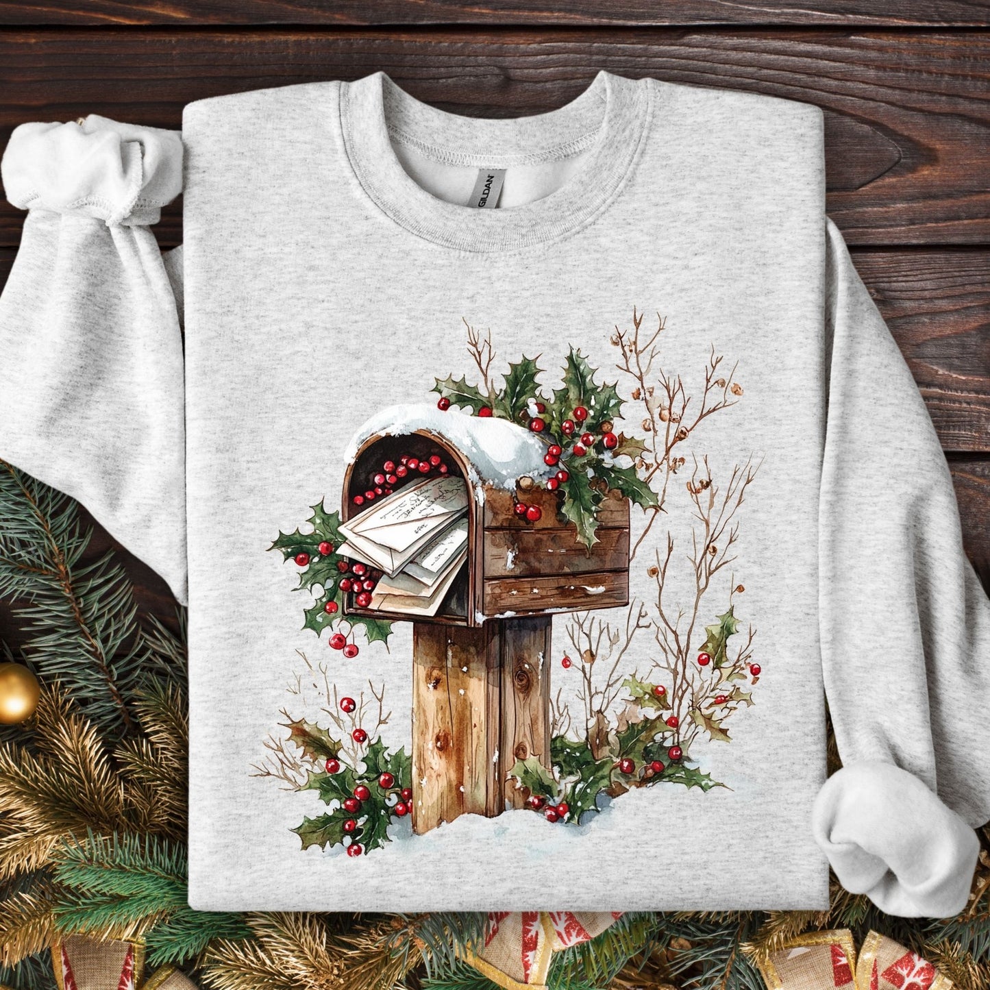 Ash Gildan fleece sweatshirt with a watercolor rustic mailbox, snow, and holly berries design.