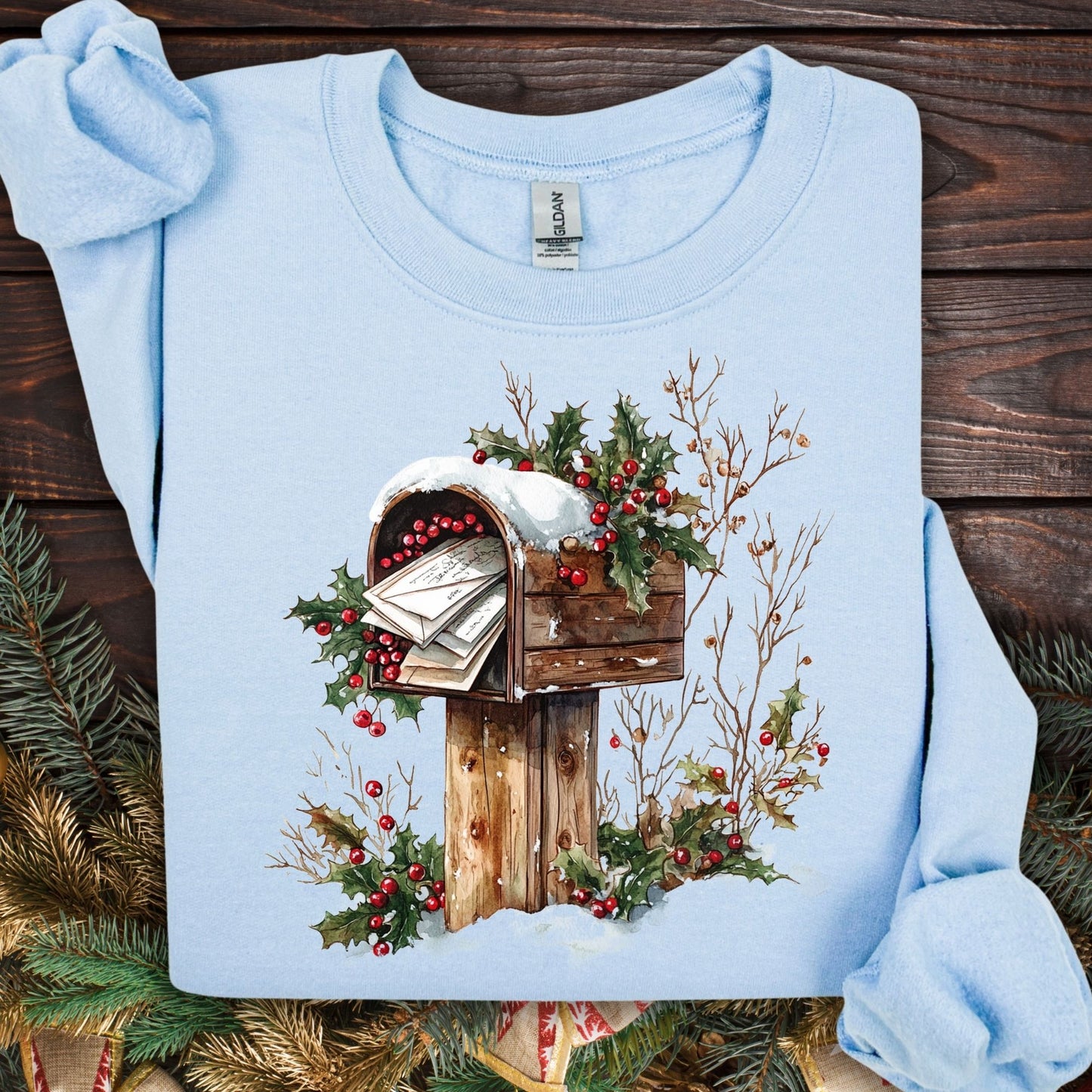 Light blue Gildan fleece sweatshirt with a watercolor rustic mailbox, snow, holly berries, and letters to Santa design.
