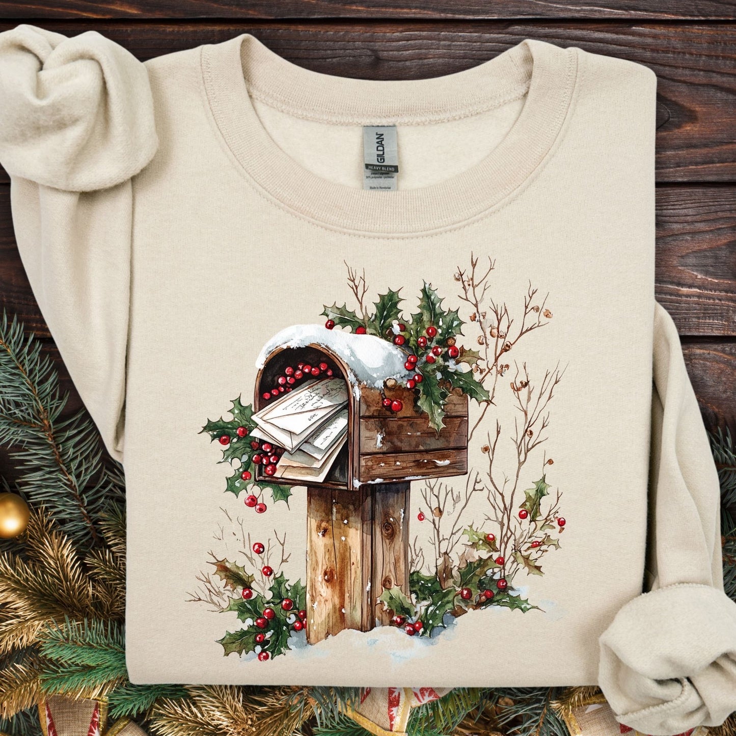 Sand Gildan sweatshirt with watercolor rustic mailbox, snow, and holly berries design.