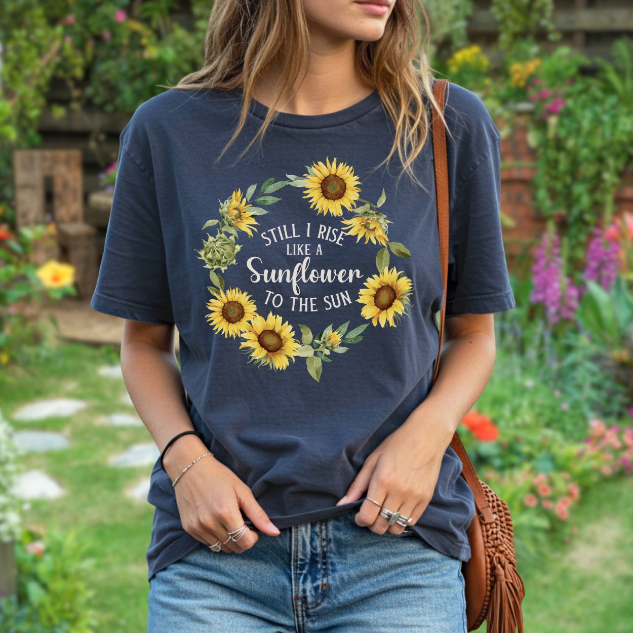 Navy garment-dyed t-shirt with a sunflower wreath and "Still I Rise Like a Sunflower to the Sun" text.