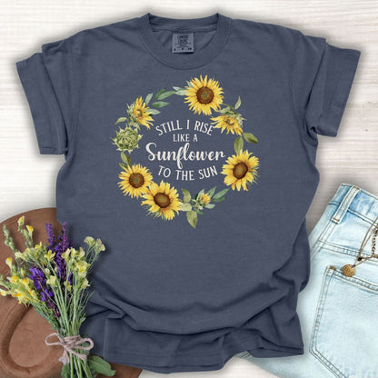 Denim S t-shirt with "Still I Rise Like a Sunflower to the Sun" in a sunflower wreath.