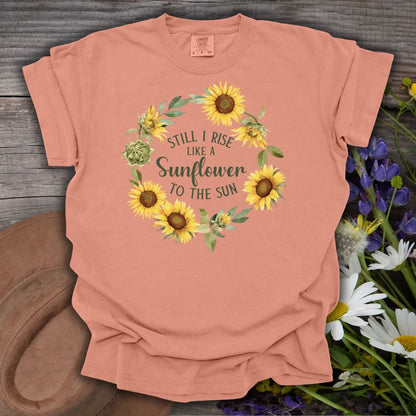 Terracotta S-size t-shirt with a sunflower wreath and "Still I Rise Like a Sunflower to the Sun" text.