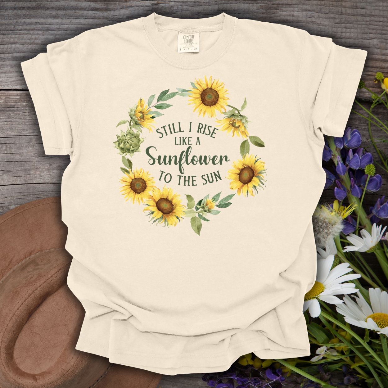 Ivory S-sized cotton t-shirt with "Still I Rise Like a Sunflower to the Sun" in a sunflower wreath.