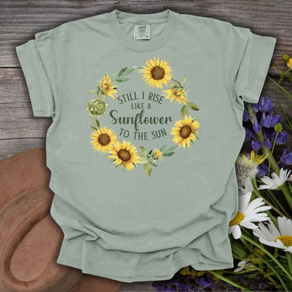Bay green t-shirt with "Still I Rise Like a Sunflower to the Sun" in a sunflower wreath.