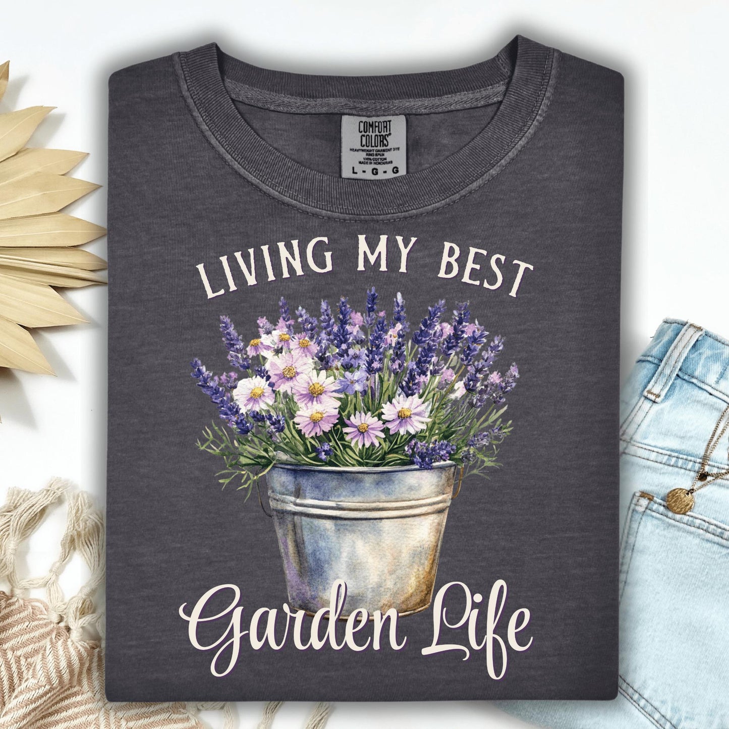 Pepper Comfort Colors t-shirt with "Living My Best Garden Life" text and a bucket of lavender and daisies.
