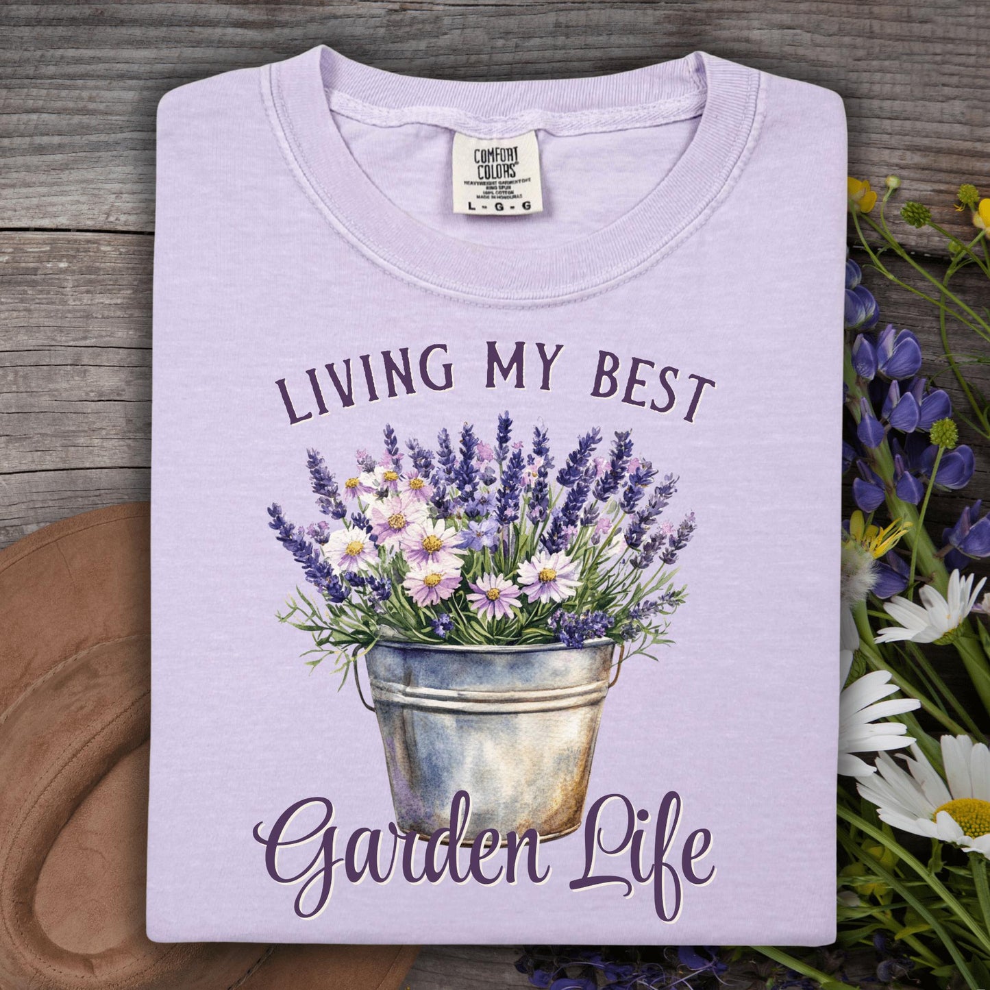 Orchid purple "Living My Best Garden Life" t-shirt with a lavender and daisy flower pot design.