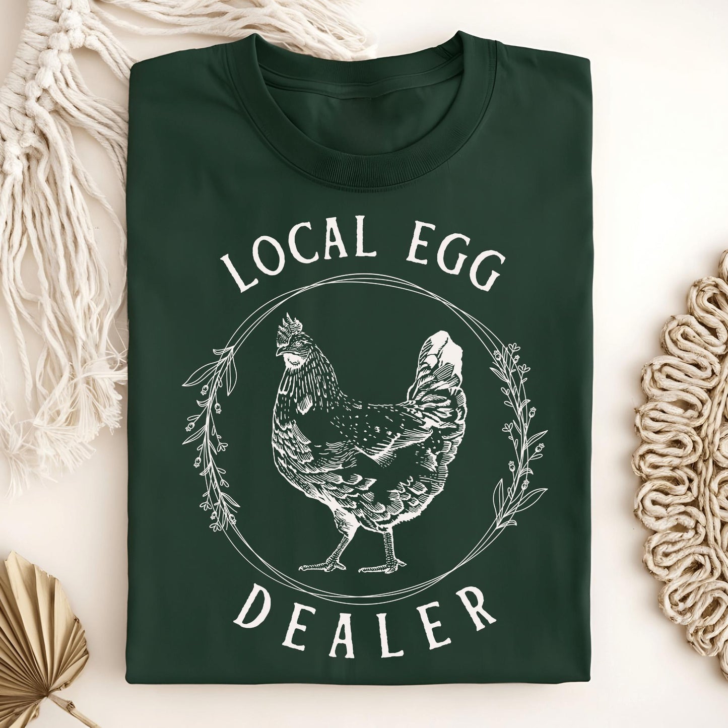 Forest Green S-size t-shirt with "Local Egg Dealer" text and a vintage hen in a floral wreath design.