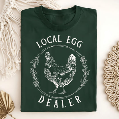 Forest Green S-size t-shirt with "Local Egg Dealer" text and a vintage hen in a floral wreath design.
