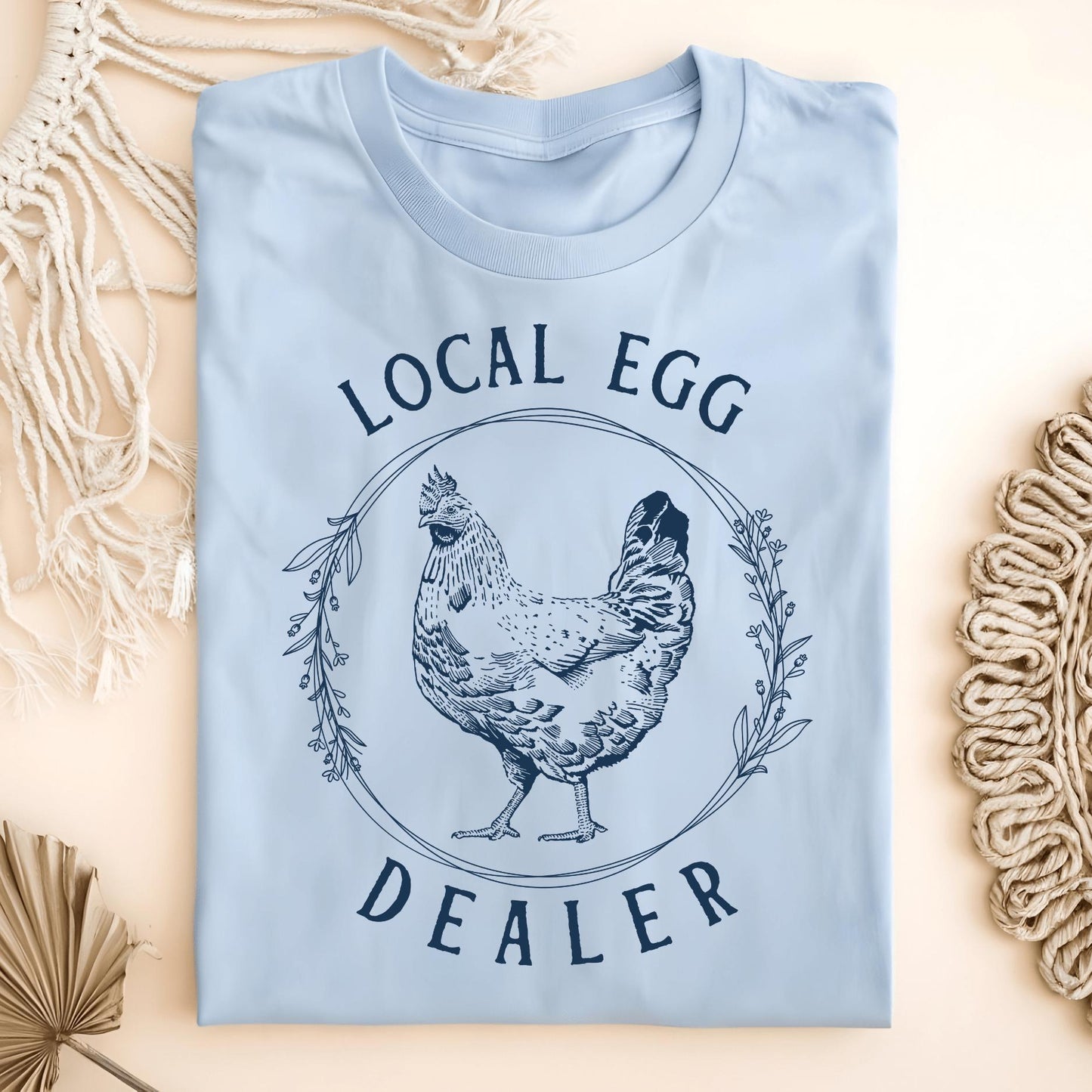 Light blue Local Egg Dealer t-shirt, size S, with a vintage hen and floral wreath graphic.