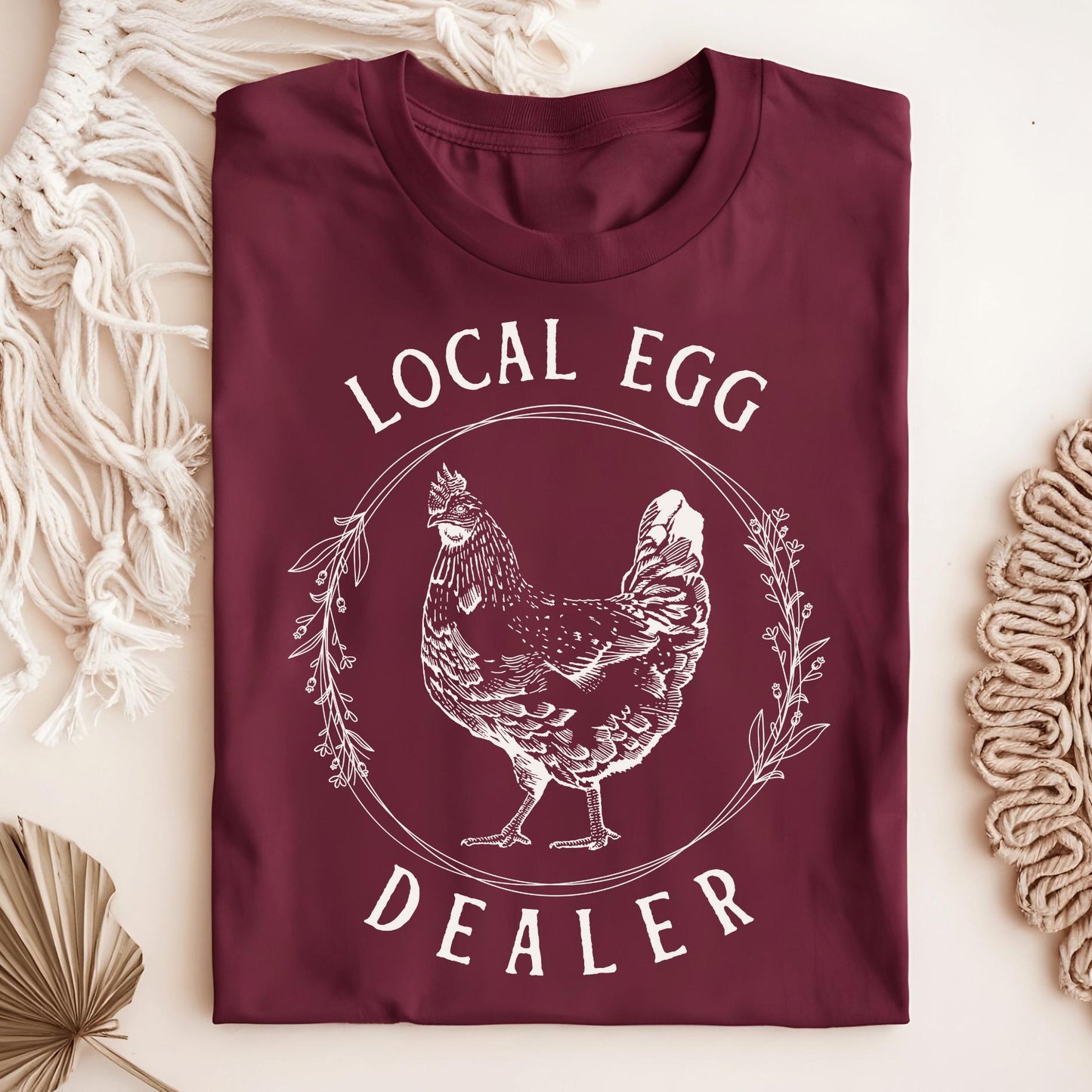 Maroon Local Egg Dealer T-shirt, size S, with a vintage hen and floral wreath design on heavyweight cotton.
