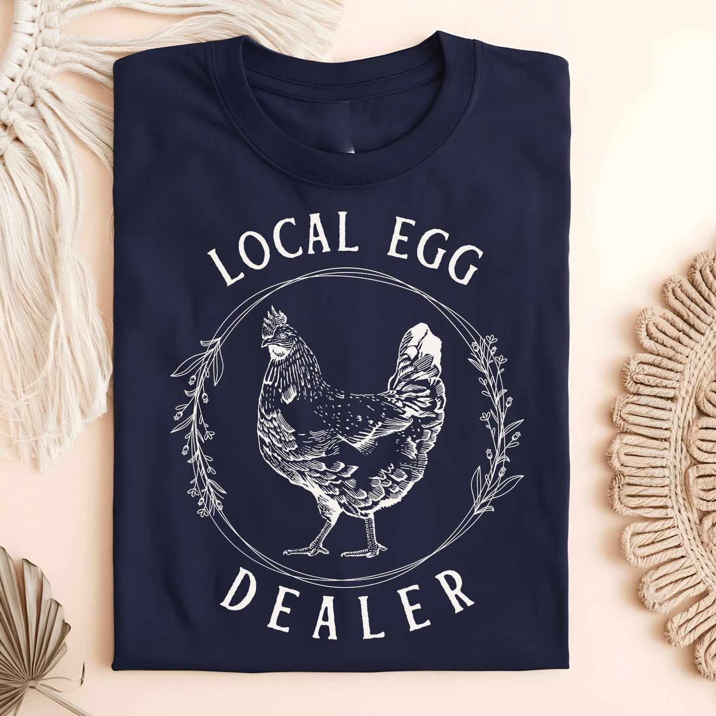 Navy S Local Egg Dealer t-shirt with a vintage hen and floral wreath design on heavyweight cotton.