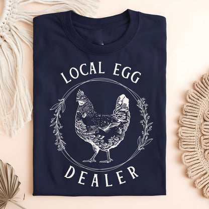 Navy S Local Egg Dealer t-shirt with a vintage hen and floral wreath design on heavyweight cotton.