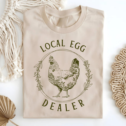 Sand Local Egg Dealer t-shirt with a vintage hen and floral wreath design, made from soft, heavyweight cotton.