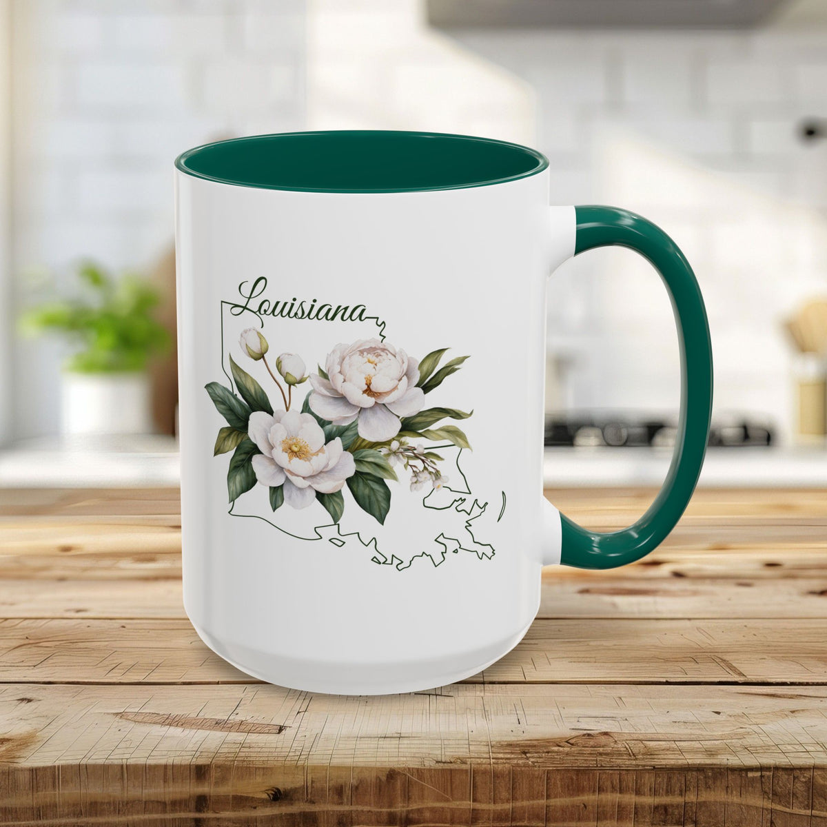 White 15oz ceramic mug with green interior and handle, featuring a watercolor magnolia bouquet over a Louisiana state outline.
