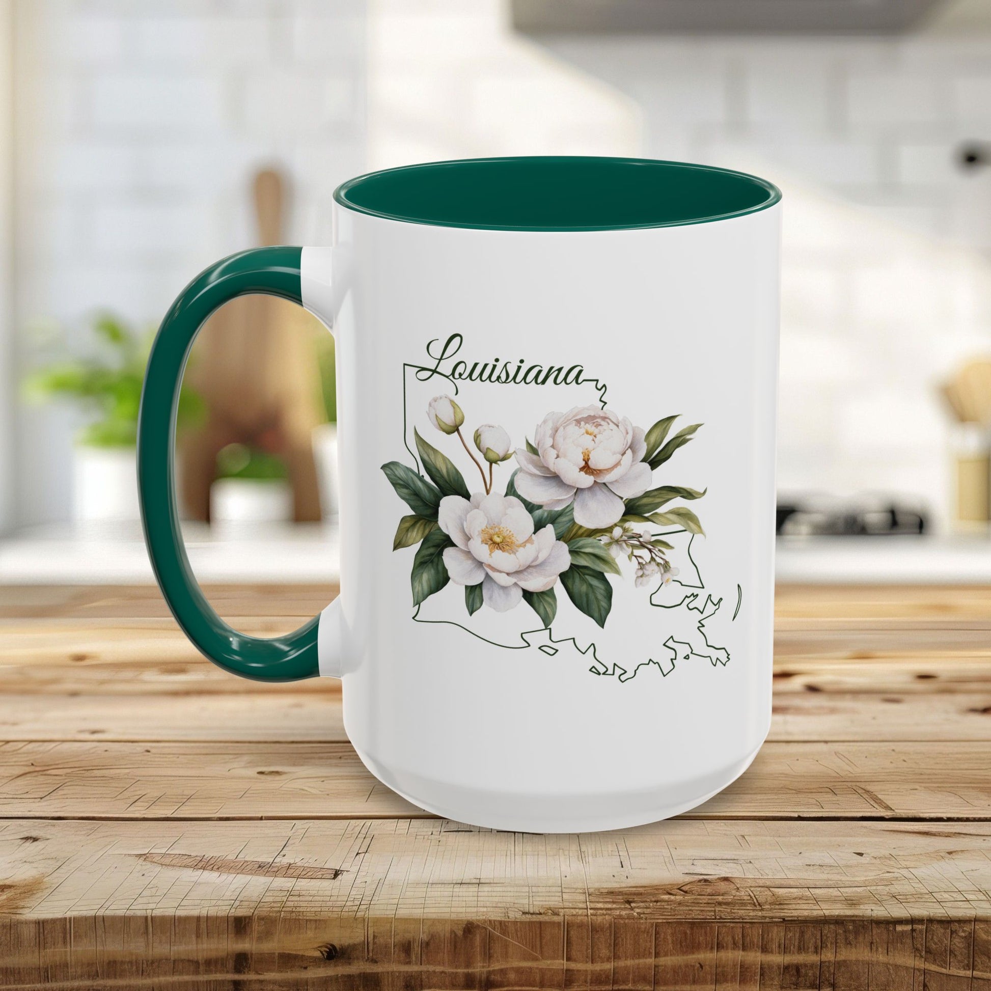 White ceramic mug with green interior and handle, featuring a magnolia bouquet over a Louisiana state outline.