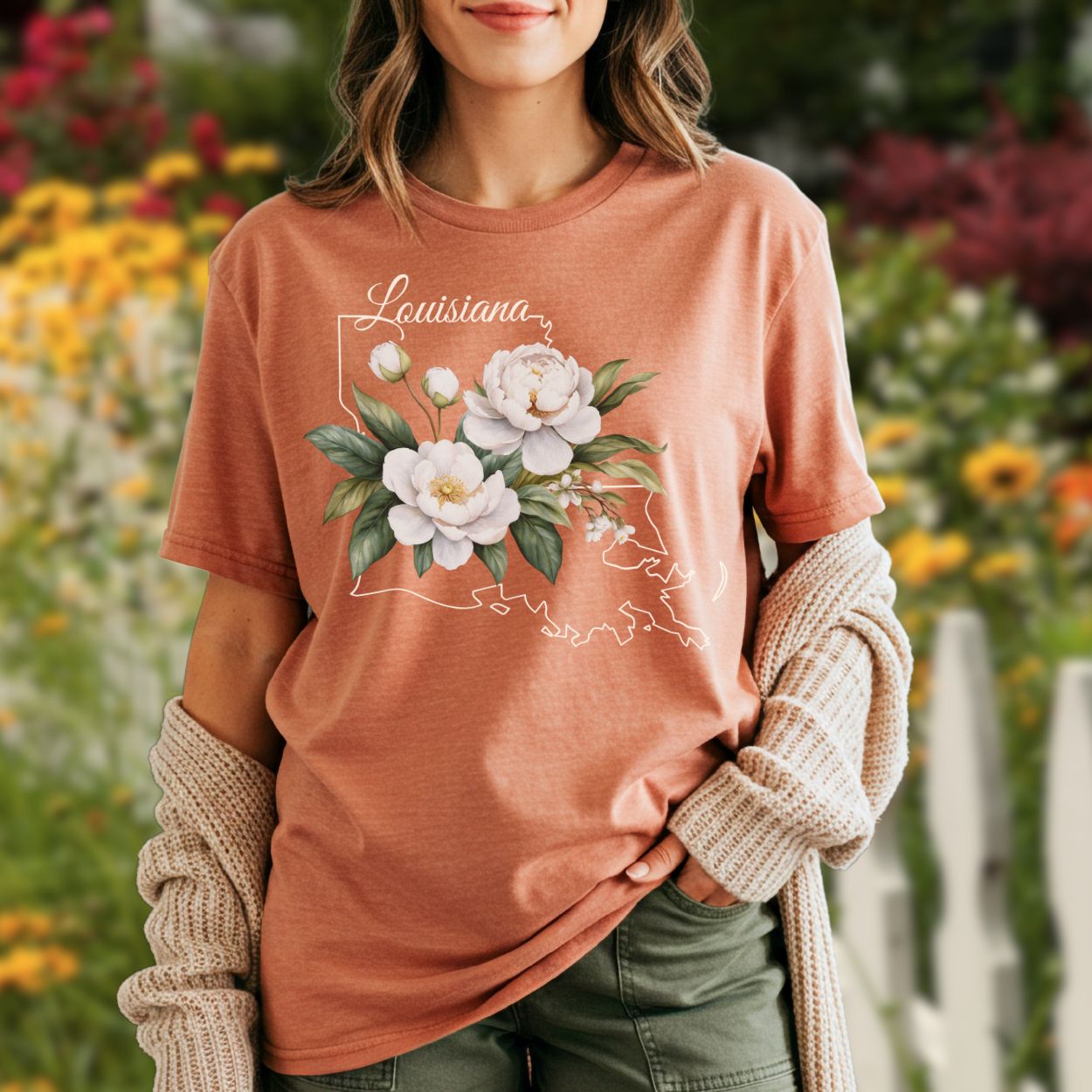 Garment-dyed, relaxed-fit t-shirt in a faded hue with a magnolia illustration over a Louisiana outline.