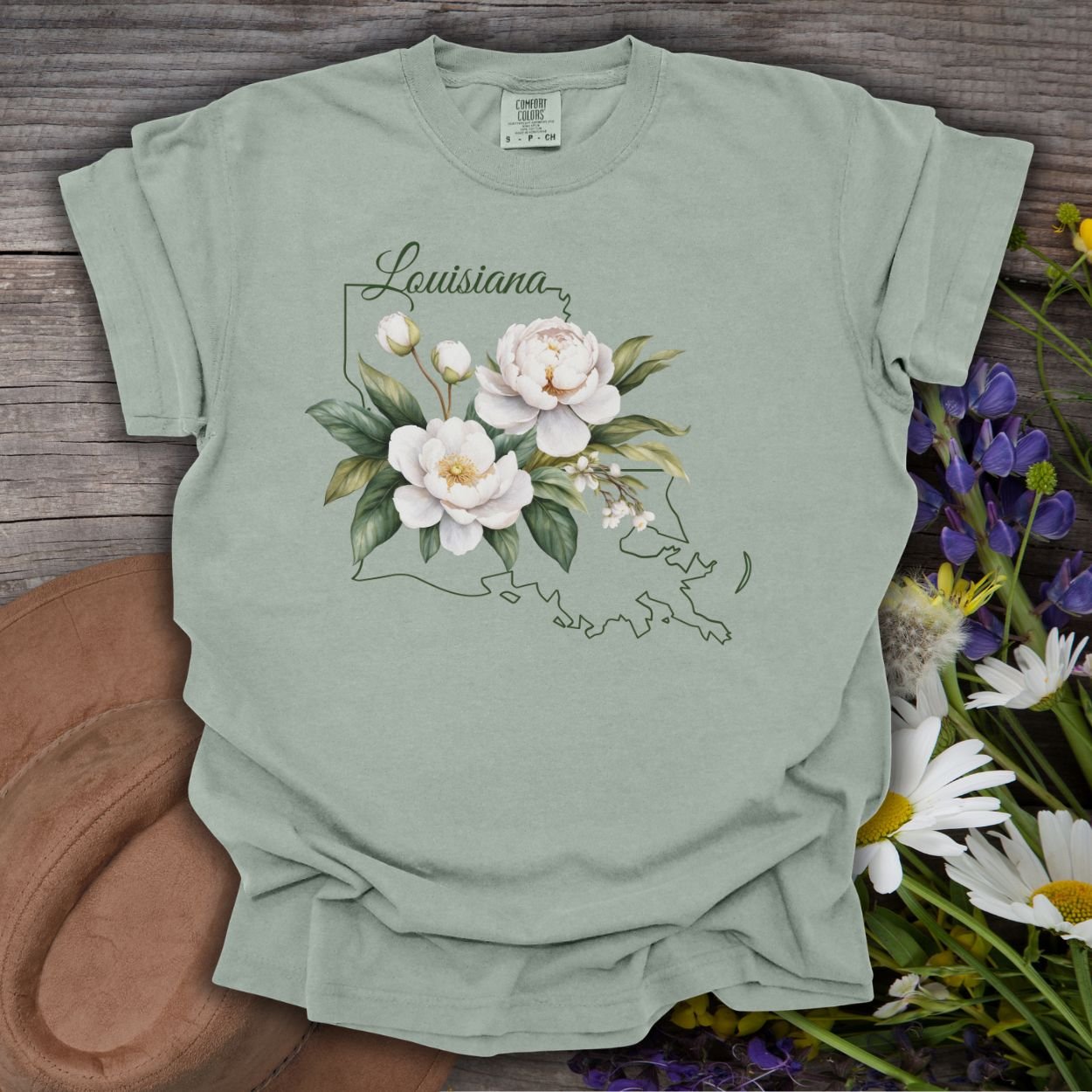 Bay green garment-dyed cotton t-shirt with a magnolia illustration over a Louisiana outline.
