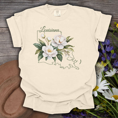 Ivory garment-dyed cotton t-shirt with a magnolia illustration layered over a Louisiana outline.