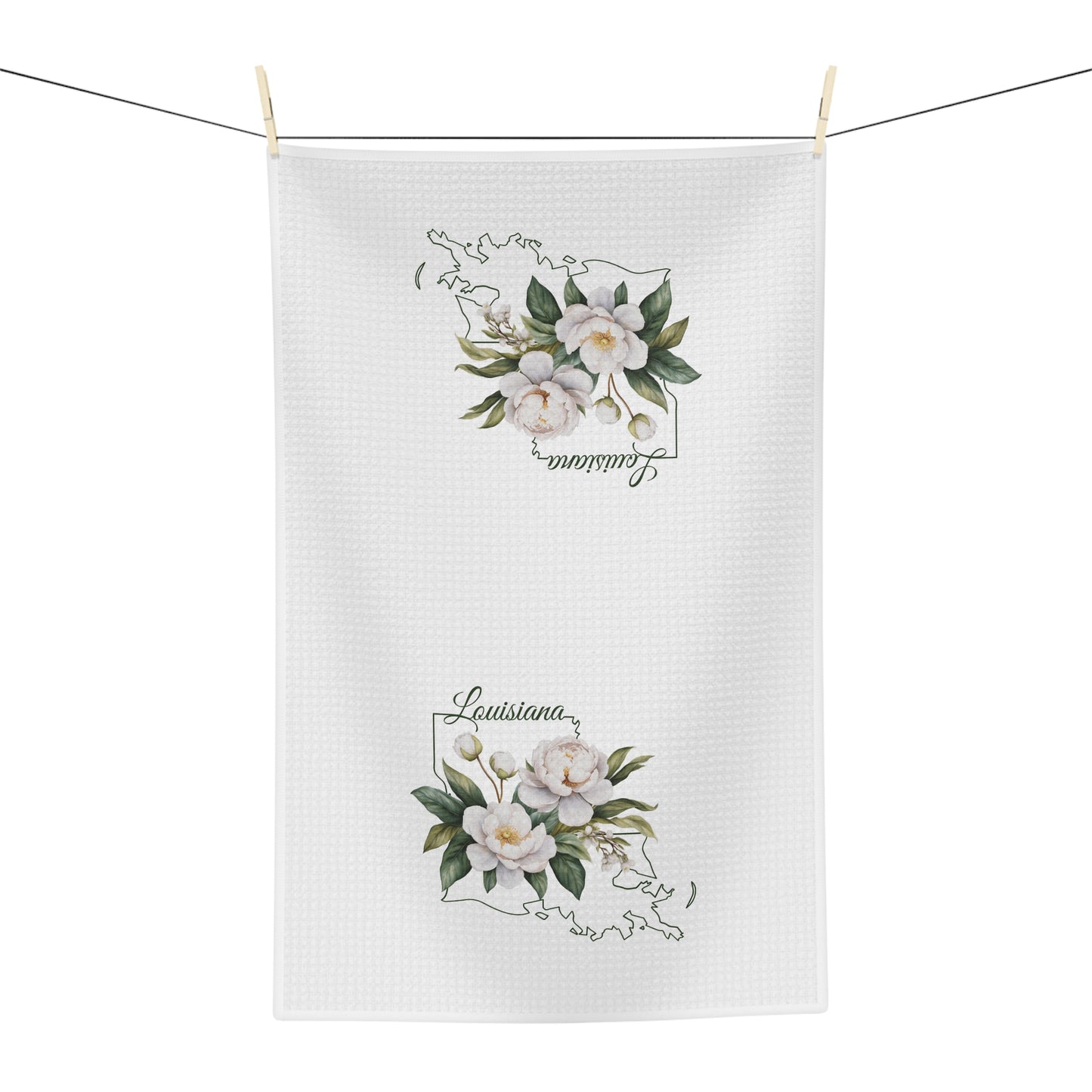 White microfiber tea towel with hand-drawn magnolias and "Louisiana" text over a state outline.