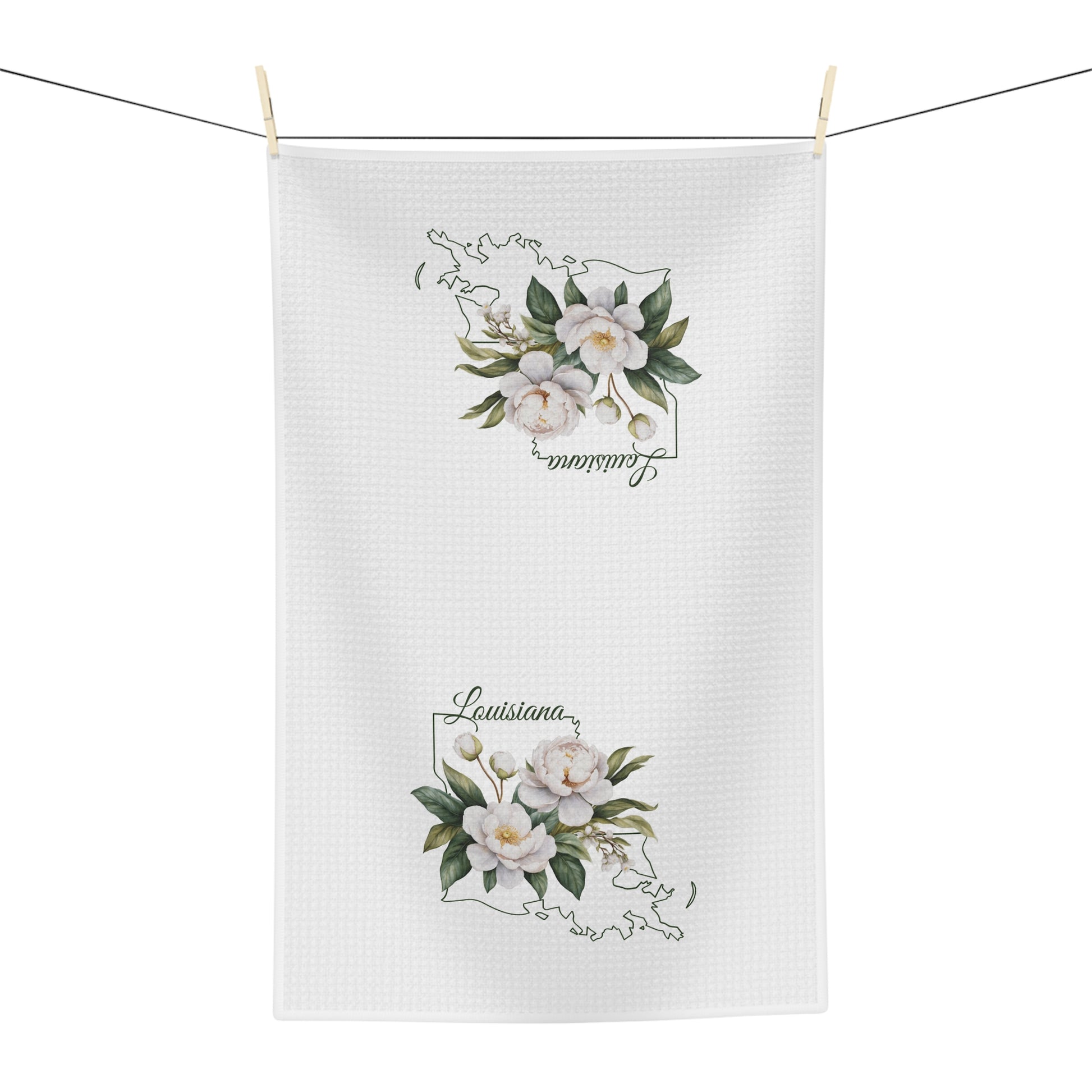White microfiber tea towel with hand-drawn magnolias and "Louisiana" text over a state outline.