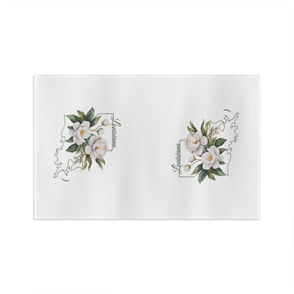 White microfiber tea towel with hand-drawn magnolias over a Louisiana outline.
