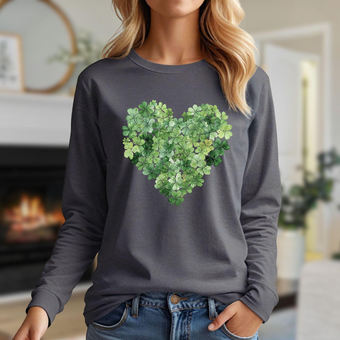 Woman in a charcoal long sleeve tee with a heart made of green clover leaves.