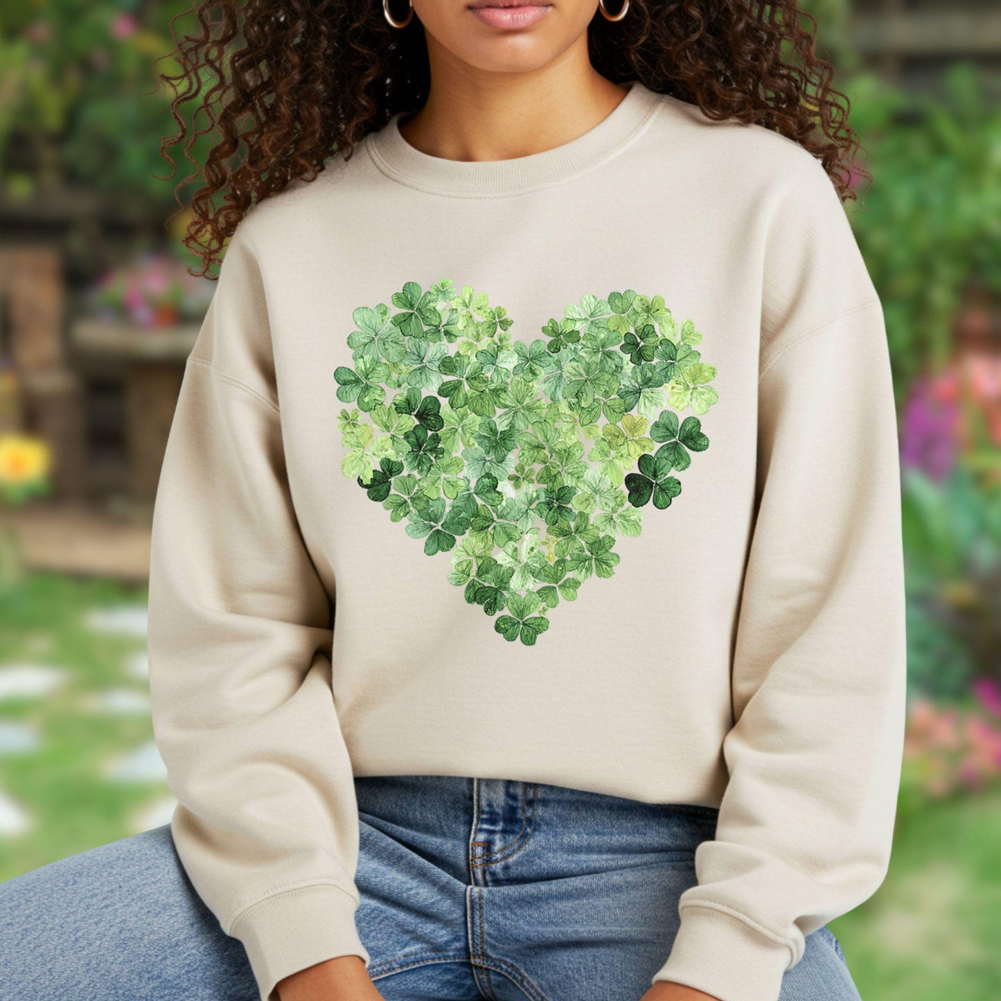 Beige sweatshirt with a large green heart made of four-leaf clovers.