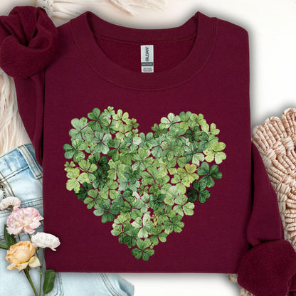 Maroon sweatshirt with a heart-shaped design made of green four-leaf clovers.