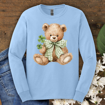 Light blue long sleeve tee with a watercolor teddy bear holding clovers and wearing a green checkered bow.